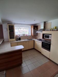 a kitchen with a sink and a stove top oven at Ubytovanie Kubik 473 in Liptovský Mikuláš
