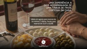 a advertisement for a bottle of wine and a plate of food at Rancho das Neves - Rancho Queimado - SC in Rancho Queimado