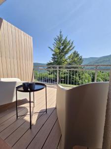 a balcony with a table and a view of the ocean at Apartmán Kľak in Fačkov