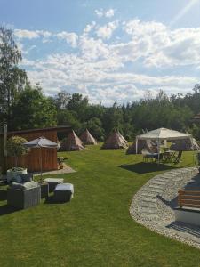 a group of tents in a field with grass at Privat Glamping Spielberg in Spielberg
