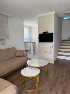 a living room with a couch and a table at Villa Tri tačke in Debeljaci