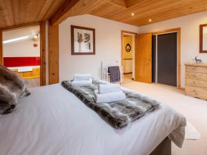 a bedroom with a large white bed with a blanket at Chalet Bolay in Montriond
