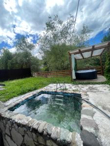a hot tub in a garden with a wooden fence at Home N 57 in Dilijan