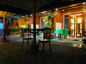 a ping pong table and chairs in a patio at Nature Rock Ella in Ella