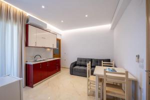 a kitchen and living room with a table and a couch at Villa HENA in Sarandë
