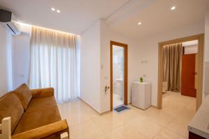 a living room with a couch and a bathroom at Villa HENA in Sarandë