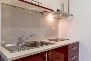 a kitchen with a sink and a counter at Villa HENA in Sarandë +42 photos