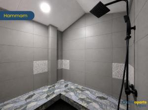 a shower in a room with white tiles at Chic apart with parking and balcony in Yaoundé +28 photos