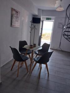 a dining room with a table and chairs in a room at ANGIRA - Koroni Apartments in Koroni
