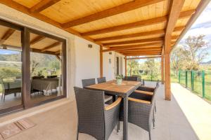 an outdoor dining room with a table and chairs at S'istella suite in Olbia