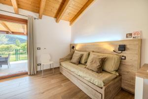 a bedroom with a couch in a room with a patio at S'istella suite in Olbia