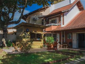 a house with a patio in front of it at Take it Easy Hostel in Florianópolis