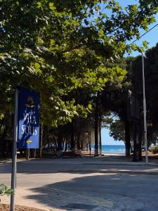 a blue sign on the side of a beach at Villa SOLIS in Vlorë