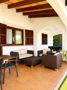 a living room with couches and a pool table at Can Brenno in Port de Pollensa