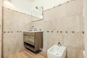 a bathroom with a sink and a toilet and a mirror at S'istella suite in Olbia +60 photos