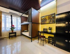 a room with a desk and a bunk bed at Old Lane Homestay in Hoi An