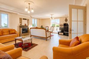 a living room with orange furniture and a fireplace at Villa Kubra in Dalyan