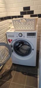 a washer and dryer in a small room at La Maison Bleue - Escale en Ubaye in Saint-Pons