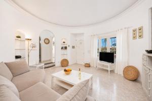 a white living room with a couch and a table at Villa Alisa in Tías