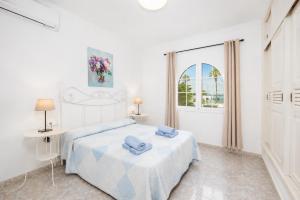a white bedroom with a bed and a window at Villa Alisa in Tías +13 photos