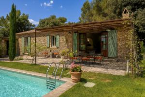 a house with a swimming pool in front of a house at Villa Hautvallon - Peaceful Escape in Provence in Gordes
