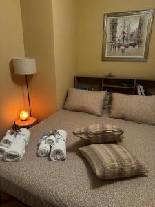 a bed with towels and pillows on top of it at Casetta di Pucci in Capitone