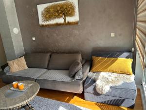 a living room with a couch and a table at CENTRAL POINT APARTMENT - City centar Zenica- in Zenica