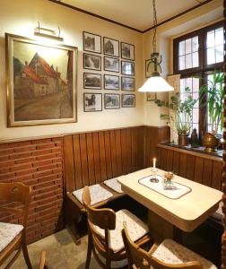 
a dining room table with a painting on the wall at Hotel Kröger in Ennigerloh
