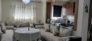 a living room with a couch and a table at appartement forêt diplomatique in Tangier