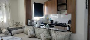 a living room with a couch and a kitchen at appartement forêt diplomatique in Tangier