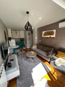 a living room with a couch and a table at CENTRAL POINT APARTMENT - City centar Zenica- in Zenica