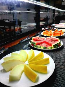 a row of plates of food on a table at Pousada Alecrim Dourado in Paraty +77 photos