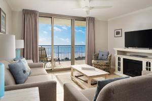 a living room with a television and a living room with a view at Kingston Plantation Condos in Myrtle Beach
