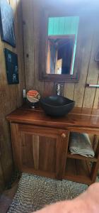 a bathroom with a black sink and a mirror at SEGUNDA BRISA in Tucker Bight