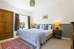 a bedroom with a bed and a window at Charcoal House in Coniston
