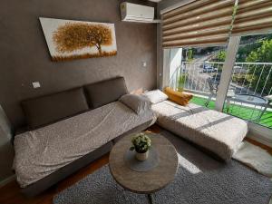 a living room with a couch and a table at CENTRAL POINT APARTMENT - City centar Zenica- in Zenica
