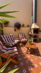 a living room with two chairs and a fireplace at La Cantera in Corbera +33 photos