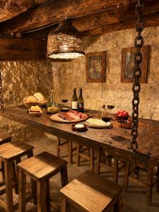 a table with food and glasses of wine on it at La Cantera in Corbera