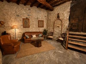 a living room with a couch and a chair at La Cantera in Corbera