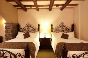 Postel nebo postele na pokoji v ubytování Hotel Quinta Mision