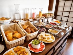 a buffet with many different types of bread and pastries at Hotel Villa del Carmen in Arequipa