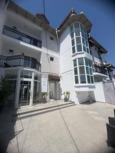 a large white building with balconies and a courtyard at Hotel MaRailiS Mangalia in Mangalia