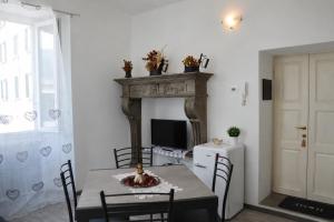 a dining room with a table and a fireplace at Lescen White Residence - swimming pool in Lezzeno