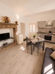 a living room with a table and a kitchen at Lescen White Residence - swimming pool in Lezzeno