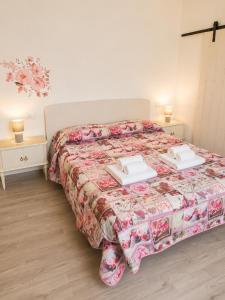 a bedroom with a bed with two towels on it at Lescen White Residence - swimming pool in Lezzeno +16 photos