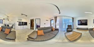 a large living room with a large couch and chairs at Elysium Garden in Belgrade
