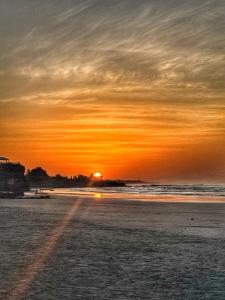 a sunset on a beach with the sun setting at Oceanfront Villa, Punta Mango in Jucuarán