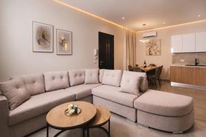 a living room with a couch and a table at Lion Exclusive Villa in Sarakinádhon