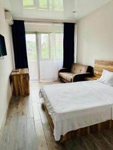 a bedroom with a large bed and a couch at Aparthotel costa in Makhinjauri +45 photos