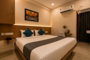 a bedroom with a large bed in a room at Hotel Elite kukatpally Near Nexus Mall in Hyderabad